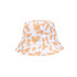 A cow print bucket hat featuring a white base with orange splashes and a circular brim. It has a logo on the side.