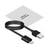 A black USB charging cable with a user manual laid beside it.