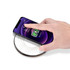 A wireless charger with a sleek, circular design and a hand placing a phone on it. The charger features a dotted pattern.