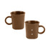 A brown ceramic coffee mug with a handle and two magnetic dots on the side, featuring a simple design.