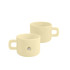 A cream-coloured ceramic mug with a magnetic feature and a handle, showcasing a sleek, minimalist design.