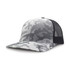 A grey and white camouflage trucker cap with a mesh back and a curved brim. It features a logo on the front.