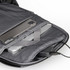A grey backpack interior with compartments for a laptop and a smartphone, featuring a charging port.