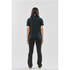 A woman wearing a black polo shirt stands with her back to the viewer, paired with black pants. The shirt has a logo.