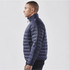 A navy puffer jacket with a high collar and side zip pockets, displayed on a male model.