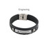 A multi-layer braided leather bracelet in black, featuring a metal clasp and a rectangular engraved plate.