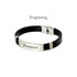 A custom leather bracelet with a black leather band and a silver metal clasp, featuring an engraved brand logo.