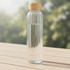 A drink bottle with a ribbed clear glass design and a wooden lid, featuring water inside.