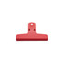 A red plastic magnetic clip with a flat base and a hole for hanging, featuring a simple design.