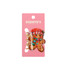 A gingerbread man hair claw in festive colours, featuring a red hat and scarf, on a pink backing with a logo.