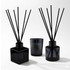An Aroma Diffuser and Candle Gift box featuring two black diffusers and a matching candle, all in sleek glass containers.