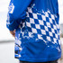 A long sleeve fishing polo in blue with a checkered pattern and abstract design. It features a logo on the sleeve.