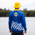 A blue long sleeve polyester fishing polo featuring a checkered pattern and a logo. A yellow bucket hat is worn.