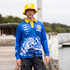 A man wearing a blue long sleeve polyester fishing polo with a graphic design and a yellow bucket hat.