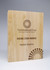 A wooden block award with a polished finish, featuring text engraving and a logo in a circular design.
