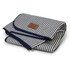 A folded picnic blanket with a navy and white striped design and a leather tag, showcasing a neat, compact appearance.