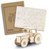 A wooden tractor model in natural wood colour, with a laser-cut template and packaging design.