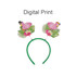 A headband with green fabric featuring pink flamingo decorations and tropical leaf designs on either side.
