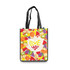 A custom tote bag featuring a vibrant fruit pattern in various colours, with black handles and a logo on the side.
