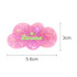 A pink iridescent hair clip shaped like a cloud with a logo, measuring 5.6cm by 3cm.