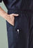 A pair of men's scrub pants in navy with an elastic waistband and multiple pockets. Features a logo.