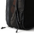 A black packing cube with a mesh side and a zippered opening, showcasing its compact design.