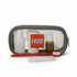 A clear travel case in grey containing white bottles, a brown bottle, a red toothbrush, and a white toothpaste tube.