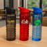 A drink bottle trio featuring black, red, and blue Tritan bottles with logos. Each has a flip-top lid and a textured grip.