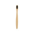 A small bamboo toothbrush with a natural wood handle and black bristles, featuring a simple design and a logo.