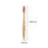 A small bamboo toothbrush with a pink bristle head and a wooden handle, featuring a logo.