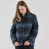 A women's plaid jacket in navy with a sherpa lining and button front, featuring two chest pockets.