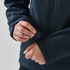 A dark blue softshell jacket with adjustable cuffs, featuring a person fastening the wrist strap.