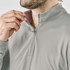 A light grey men's pullover featuring a quarter zip and a subtly contrasting inner collar. It has a logo.