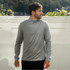 A grey men's pullover with a quarter zip, featuring long sleeves and a logo on the side.
