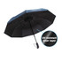 A folding ten-panel umbrella in black with a blue top and a UV resistant inner layer. Features a branded handle.