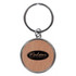A round keychain featuring a wooden design and a logo in the centre, attached to a metal keyring.