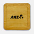 A bamboo coaster featuring a square shape and a black logo. The surface is smooth and polished.