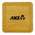 A bamboo coaster featuring a square design and a logo embossed in black.