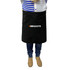 A black waist apron with a logo, worn by a person standing, dressed in casual attire.