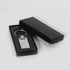 A silver keychain displayed inside a black box. The keychain has a rectangular shape with a polished finish.