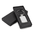 A rectangular metal keychain in a sleek black box, featuring a shiny silver finish and a simple design.