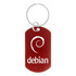 A red dog tag keychain featuring a spiral design and a logo. It has a silver keyring attached.