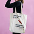 A calico tote bag with gusset, featuring a logo and text, displayed against a pink background.