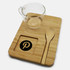 A glass cup, bamboo tray, and wooden spoon, featuring a logo on the tray. Natural tones dominate the set.