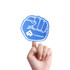A blue foam mitt shaped like a fist held by a hand, featuring a logo on the palm side.