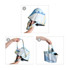 A folding umbrella in shades of blue and yellow, styled like a handbag, held in hands for demonstration.
