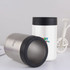 A 14oz stainless steel stubby holder in silver and white, featuring a black lid and a logo.
