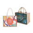 Two tote bags are displayed: one is canvas with a colourful design and logo, while the other is jute with a detailed illustrated scene.