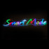 A neon LED sign features the words "Smart Mode" in vibrant colours of blue, pink, green, and yellow. It has a stylish design.
