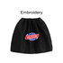 A black boot cover with a round logo featuring red and blue elements, and an embroidered text design.